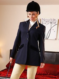 FreeKiloPics presents: Clare R seductifvely removes her riding gear leaving on only opaque hold ups and sheer underwear